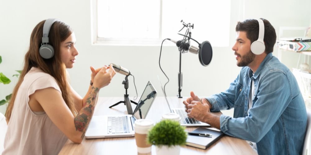 Content creators recording podcast episode with professional audio equipment