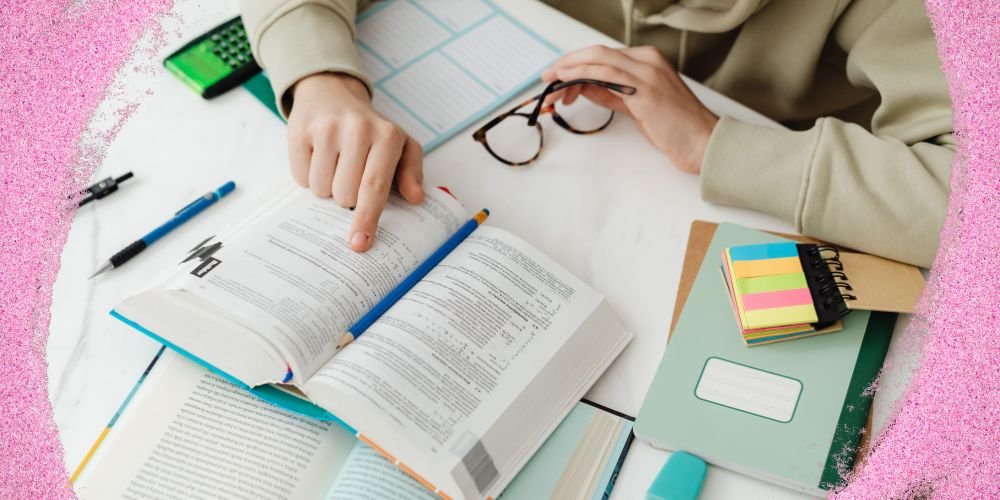Student studying with books, notes, and learning materials